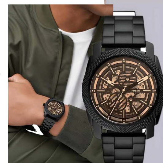 ACCHA TIME black skeleton automatic watch with gold gears, textured bezel, and stainless steel link bracelet on wrist